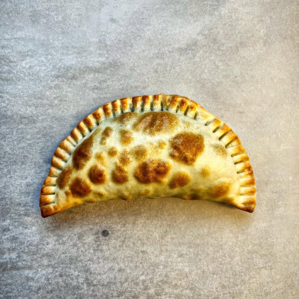 Spinach empanada shaped traditionally with fork